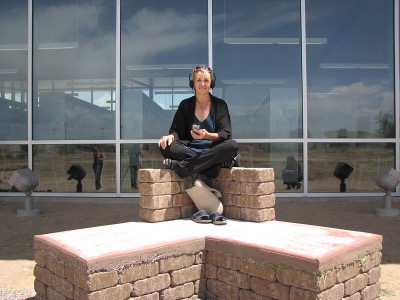 andrea polli sitting on a sculpture